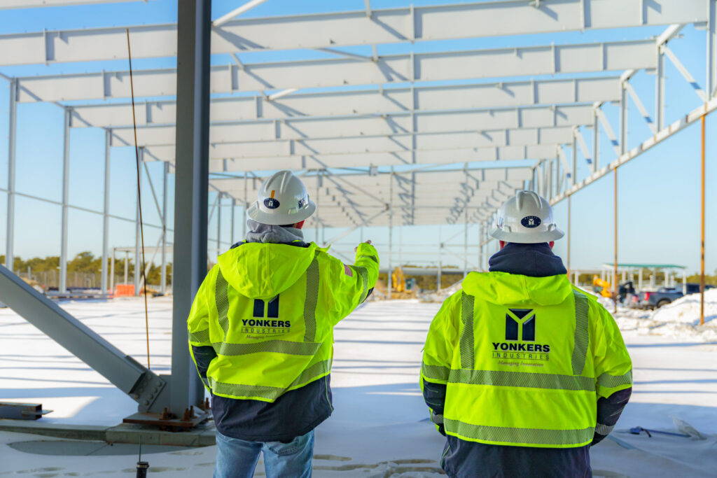 yonkers industries construction management - A diverse team of professionals collaborating on construction management project
