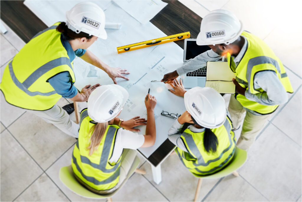 yonkers industries construction management - Construction team collaborating on innovative design strategies for industrial a